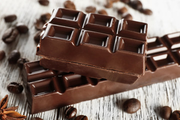 Stuffed chocolate with coffee beans on wooden table, closeup