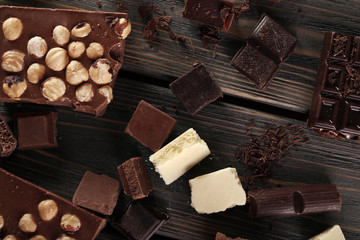 Set of chocolate with hazelnut on wooden table, top view