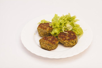 vegetarian cutlets with fresh salad on white plate