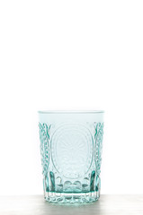 Moroccan-style glass placed on a wooden table.