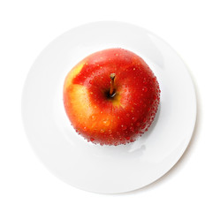 Apple on saucer isolated on white