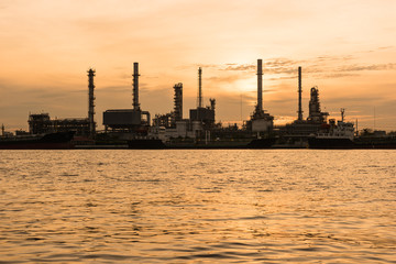 Fototapeta na wymiar Oil indutry refinery - factory with dramatic sunrise