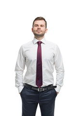 Confident businessman with hands in pockets. Isolated on white background.
