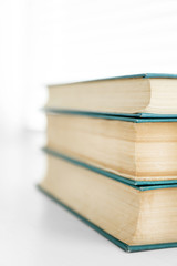 Books on white windowsill, close up
