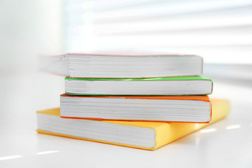 Books on white windowsill, close up