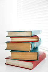 Books on white windowsill, close up