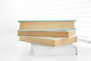 Books on white windowsill, close up