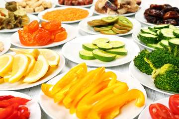 Different products on saucers on wooden table, closeup