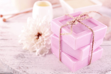 Stack of tied spa soap on wooden table, closeup