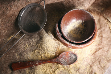 Flour with utensil on burlap cloth, closeup