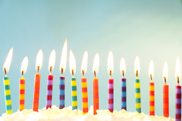 Birthday cake with candles on light background
