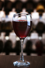 Glass of red wine on bar background
