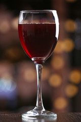 Glass of red wine on bar background
