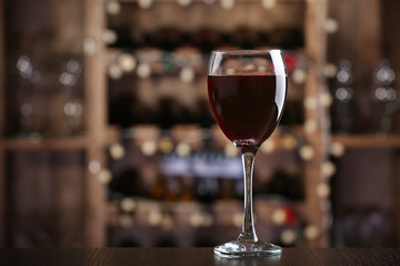 Glass of red wine on bar background