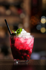 Glass of cocktail on bar background