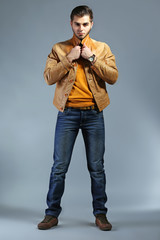 Fototapeta premium Portrait of young man on gray background