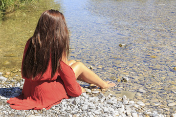 Red dressed girl at the river
