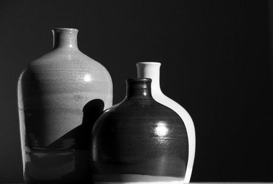 Ceramic jars on sunlight.Still Life black and white image.