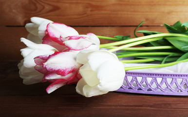 Beautiful tulips on wooden background