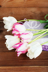 Beautiful tulips on wooden background