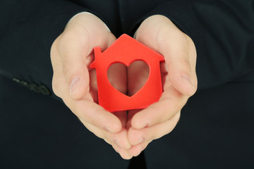 Fototapeta premium Male hands with model of house, closeup