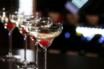 Glasses of cocktails on bar background