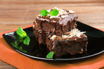 Delicious chocolate cakes on plate on table close-up
