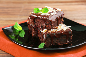 Delicious chocolate cakes on plate on table close-up