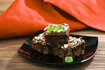 Delicious chocolate cakes on plate on table close-up