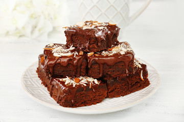 Delicious chocolate cakes on plate on table close-up