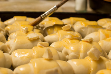 Unbaked rolls with margarine and spreading brush