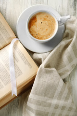 Still life with cup of coffee and book, close up
