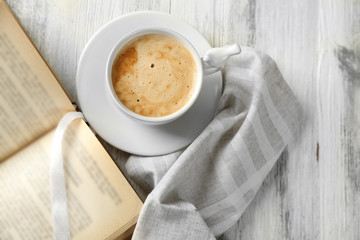 Still life with cup of coffee and book, close up