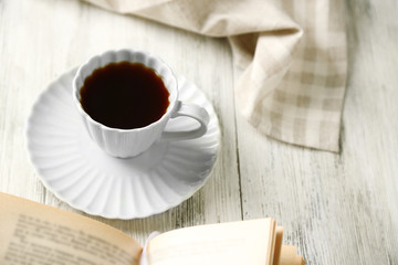 Still life with cup of coffee and book, close up
