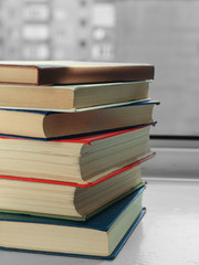Stack of books on  windowsill