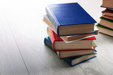 Stacks of books on wooden background