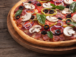 Italian delicious pizza with mushrooms and ham