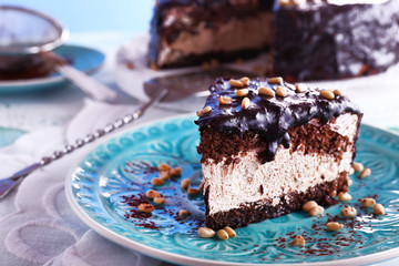 Delicious chocolate cake with icing in plate on table, closeup