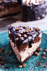Delicious chocolate cake with icing in plate on table, closeup