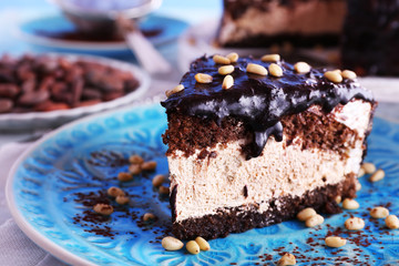 Delicious chocolate cake with icing in plate on table, closeup