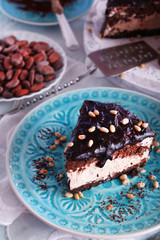 Delicious chocolate cake with icing in plate on table, closeup
