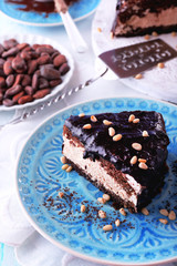 Delicious chocolate cake with icing in plate on table, closeup