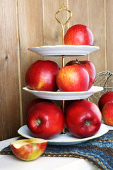 Tasty ripe apples on serving tray on wooden background