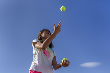 Girl juggles.