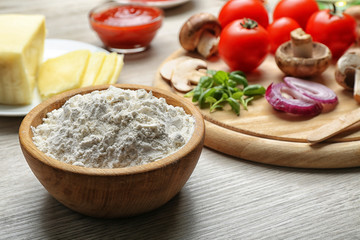 Ingredients for cooking pizza on wooden table, closeup