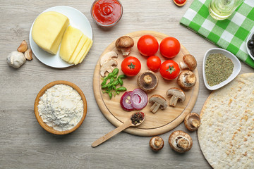 Ingredients for cooking pizza on wooden table, top view