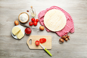 Ingredients for cooking pizza on wooden table, top view