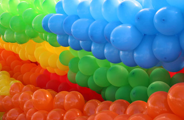 Many colorful balloons tied by colors and diagonally positioned