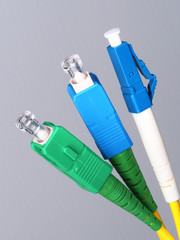 Three single fiber optic connectors used for indoor fiber optic network installation in Melbourne,...