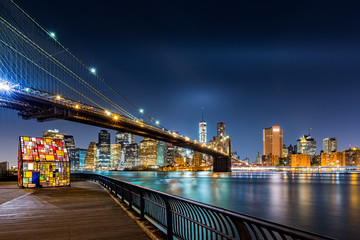 Brooklyn Bridge and the Lower Manhattan skyline by night as viewed from  Brooklyn Bridge Park in...